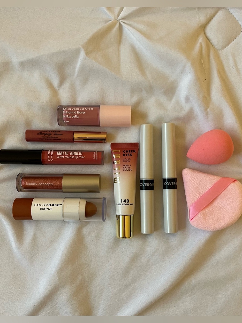 Bundle of liquid lipsticks, cheek blush, bronzer and makeup sponges